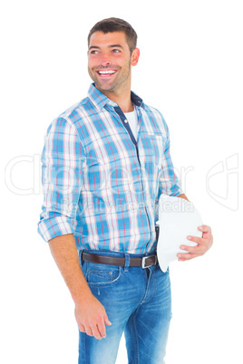 Smiling handyman with hardhat looking away