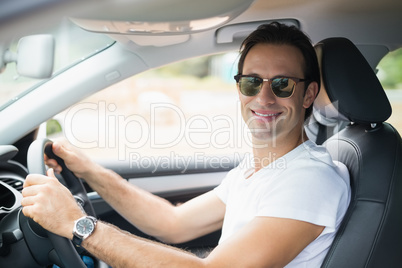 Man driving and smiling at camera