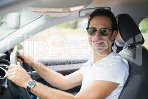 Man driving and smiling at camera