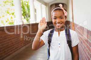 Little girl smiling in school corridor