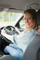 Young woman smiling while driving