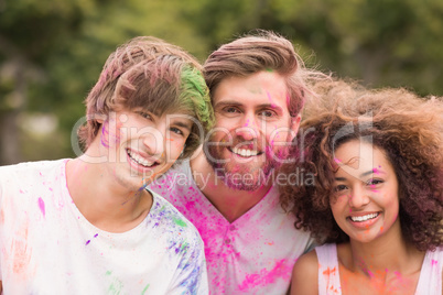 Happy friends covered in powder paint