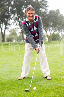 Golfer swinging his club on the course