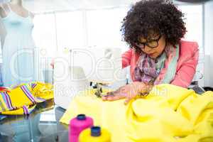 Fashion designer using sewing machine