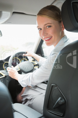 Young smiling businesswoman looking at camera