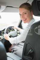 Young smiling businesswoman looking at camera