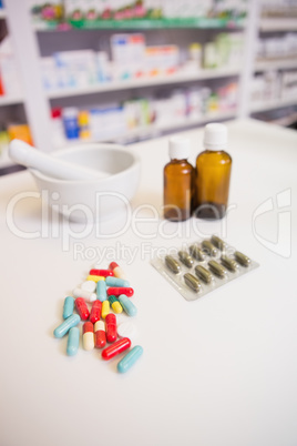 Close up of medicines and jar near a mortar