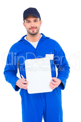 Male mechanic holding clipboard