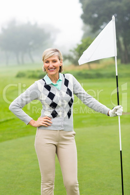 Lady golfer holding flag