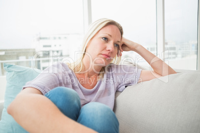 Sad woman sitting on sofa