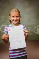 Portrait of cute little girl holding paper
