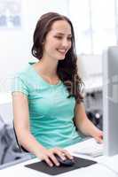 Smiling female student in computer class