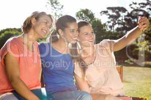 Students taking selfie outside on campus