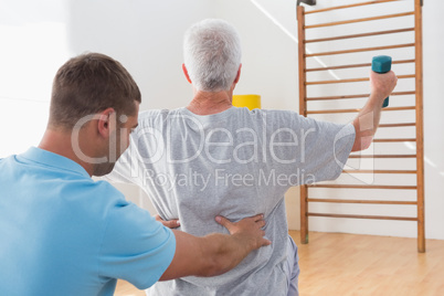 Senior man working out with his trainer