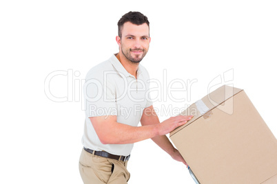 Delivery man pushing trolley of boxes