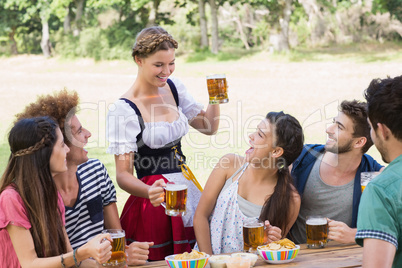 Pretty oktoberfest girl serving friends