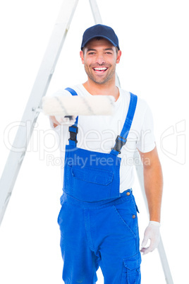 Handyman using paint roller on white background