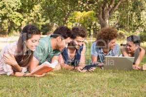 Happy friends in the park studying