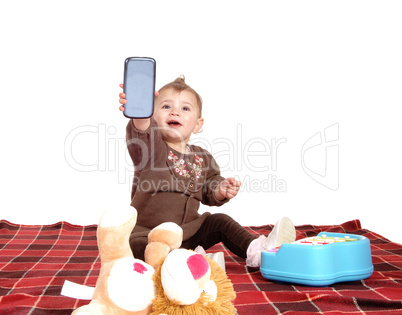 Baby holding up a cell phone.