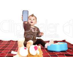 Baby holding up a cell phone.
