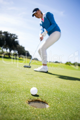 Female golfer putting her ball