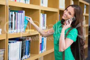 Student using her phone in library