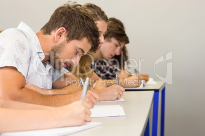 Students writing notes in classroom