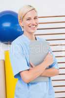 Smiling therapist holding clipboard