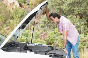 Stressed man looking at engine