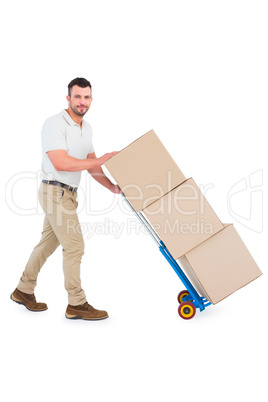 Delivery man pushing trolley of boxes Delivery man pushing trolley of boxes