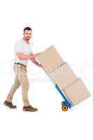 Delivery man pushing trolley of boxes