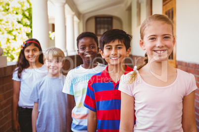 Smiling little school kids in school corridor