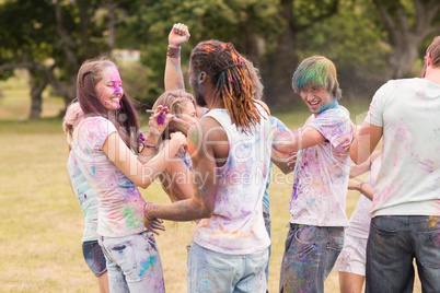 Happy friends covered in powder paint