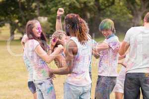 Happy friends covered in powder paint