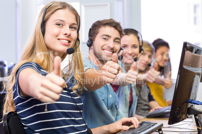 Students gesturing thumbs up in computer class