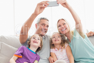 Parents taking selfie with children