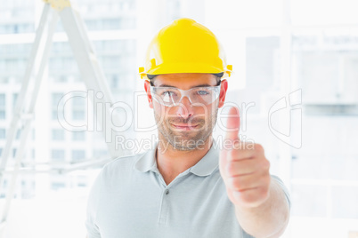 Manual worker gesturing thumbs up at site