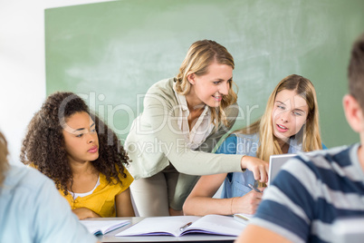 Teacher helping student in class