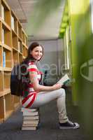 Student reading book in library