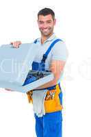 Portrait of happy repairman opening toolbox