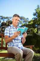 Casual man reading in the park