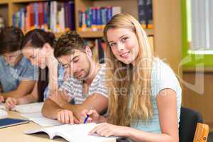 College students doing homework in library