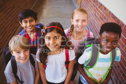 Smiling little school kids in school corridor