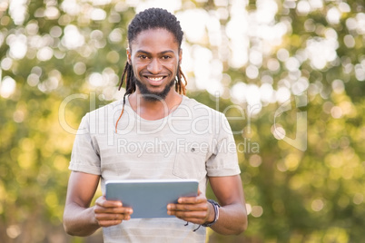 Handsome hipster using his tablet pc