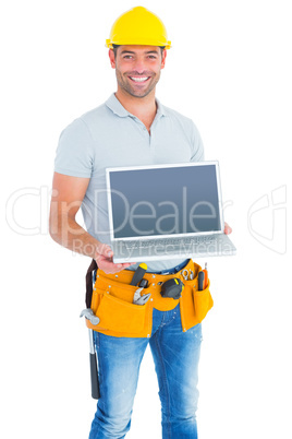 Confident repairman showing laptop