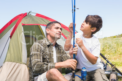 Father and son by their tent Father and son by their tent