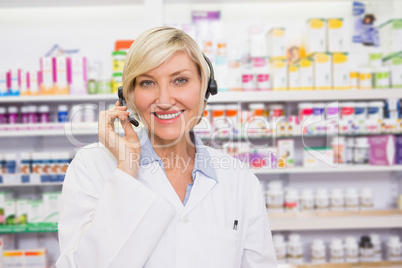 Pharmacist with headphone smiling at camera