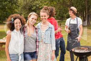 Happy friends in the park having barbecue