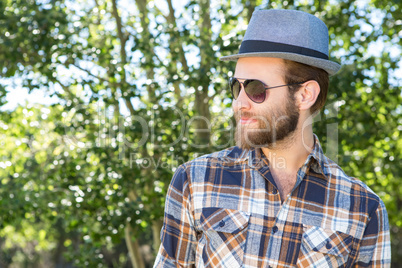 Handsome hipster smiling in the park