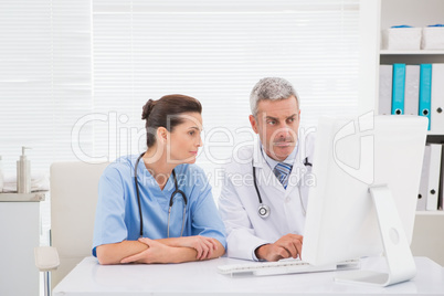 Doctors looking at computer